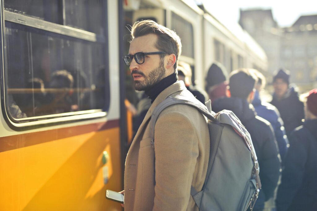 pexels-photo-837358-837358 Man in Brown Coat and Gray Backpack Posing for a Photo